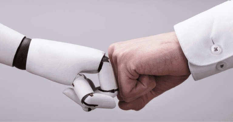 Man fist bumping robot arm