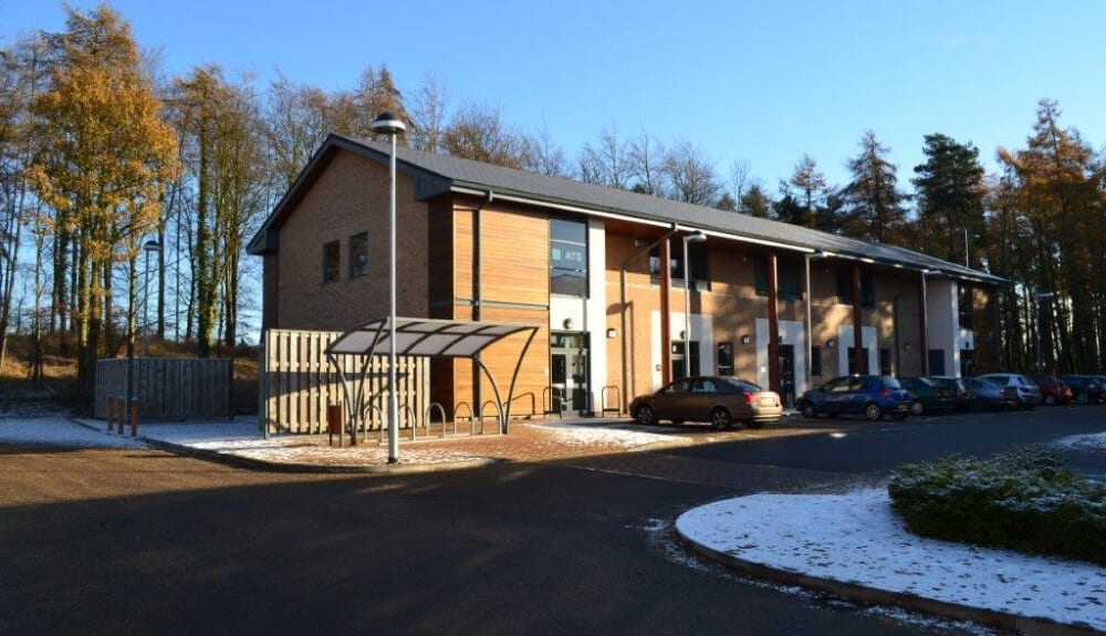 A small building with cars parked outside