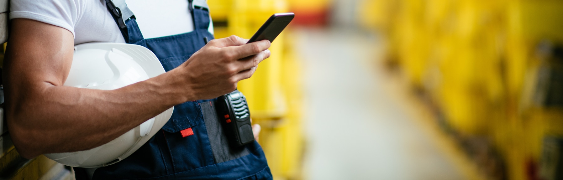 Factory worker using mobile phone.