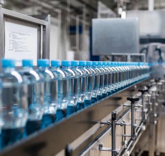 Water bottles in a conveyer belt line inside of a factory