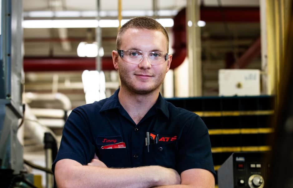 Caucasian man in safety glasses looking at the camera