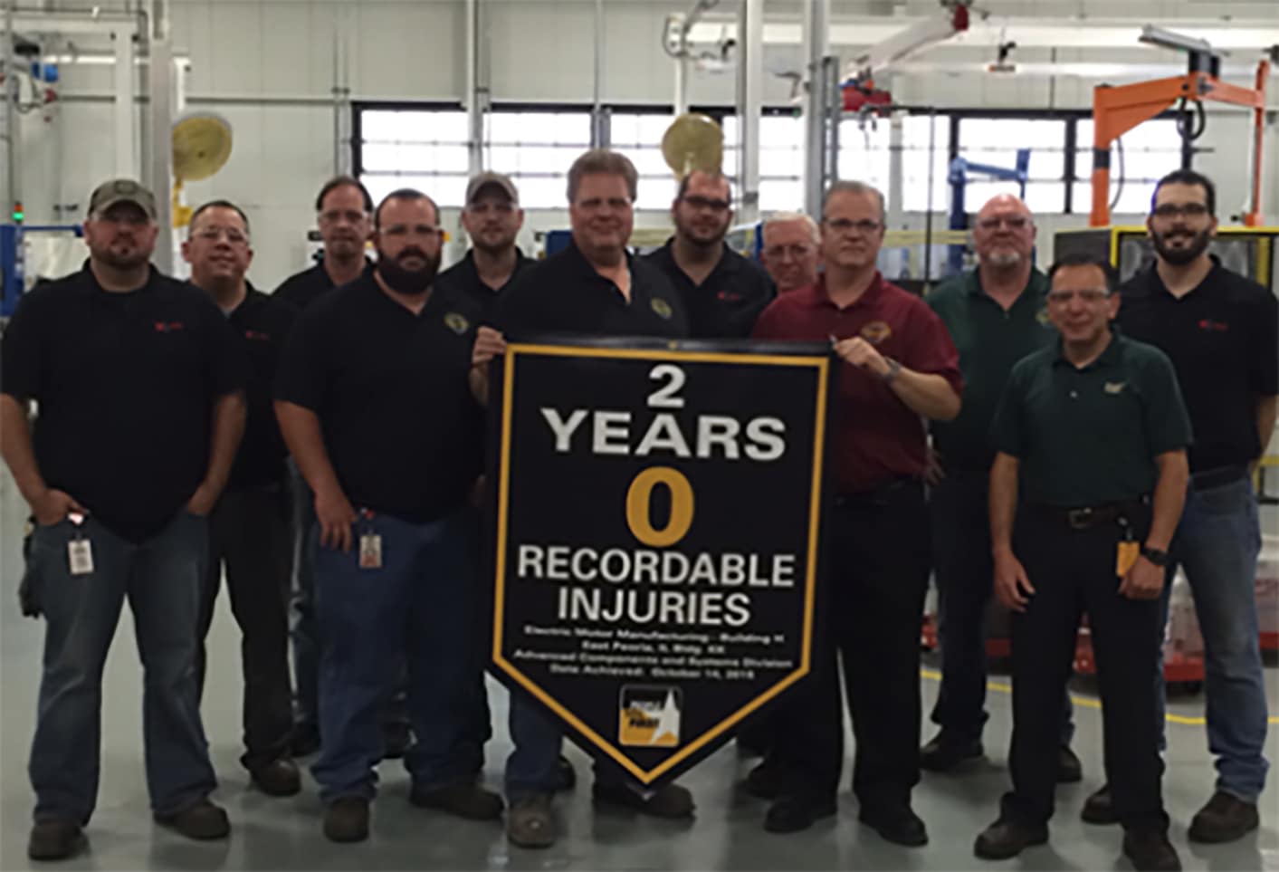 12 men behind award banner.