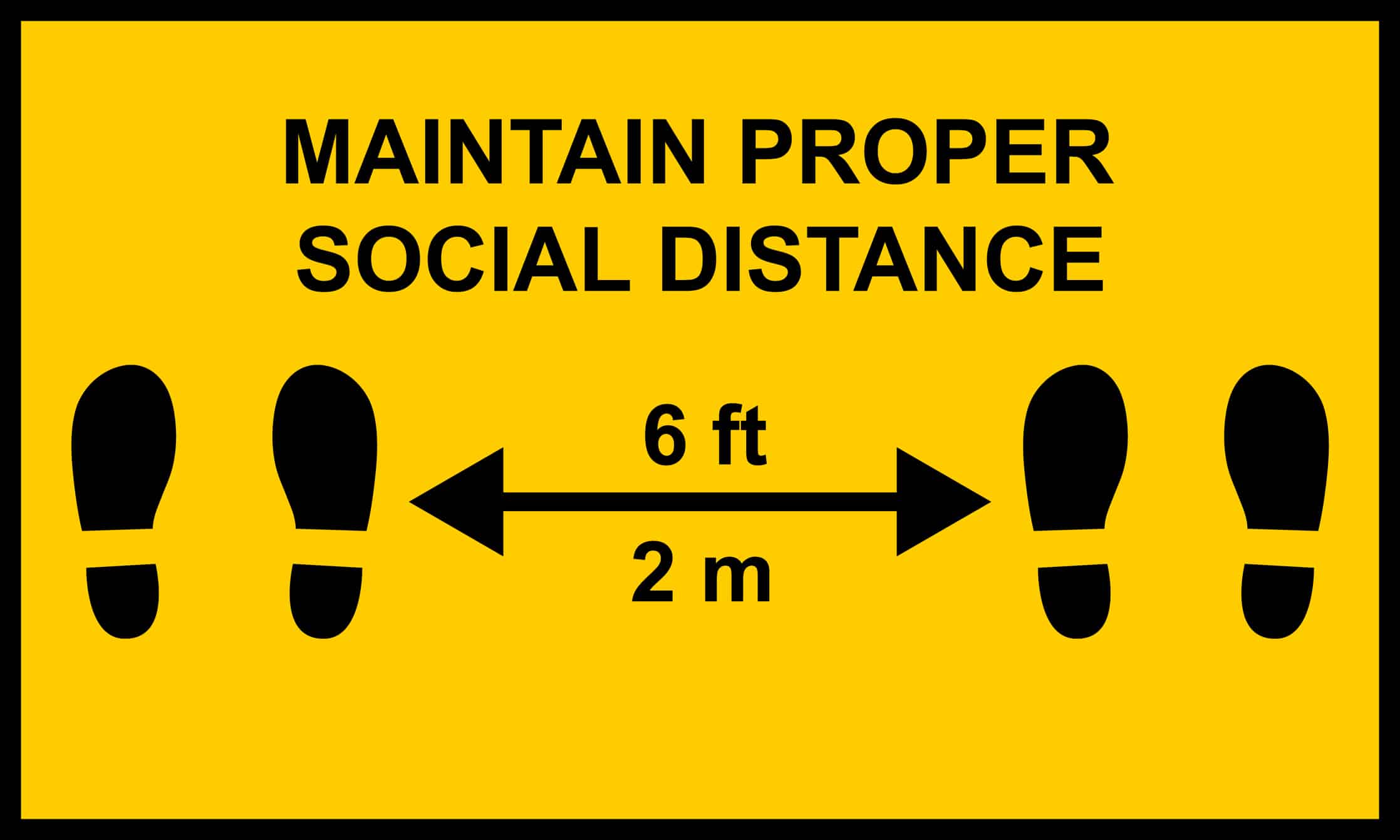 Warning sign reminding people to socially distance.