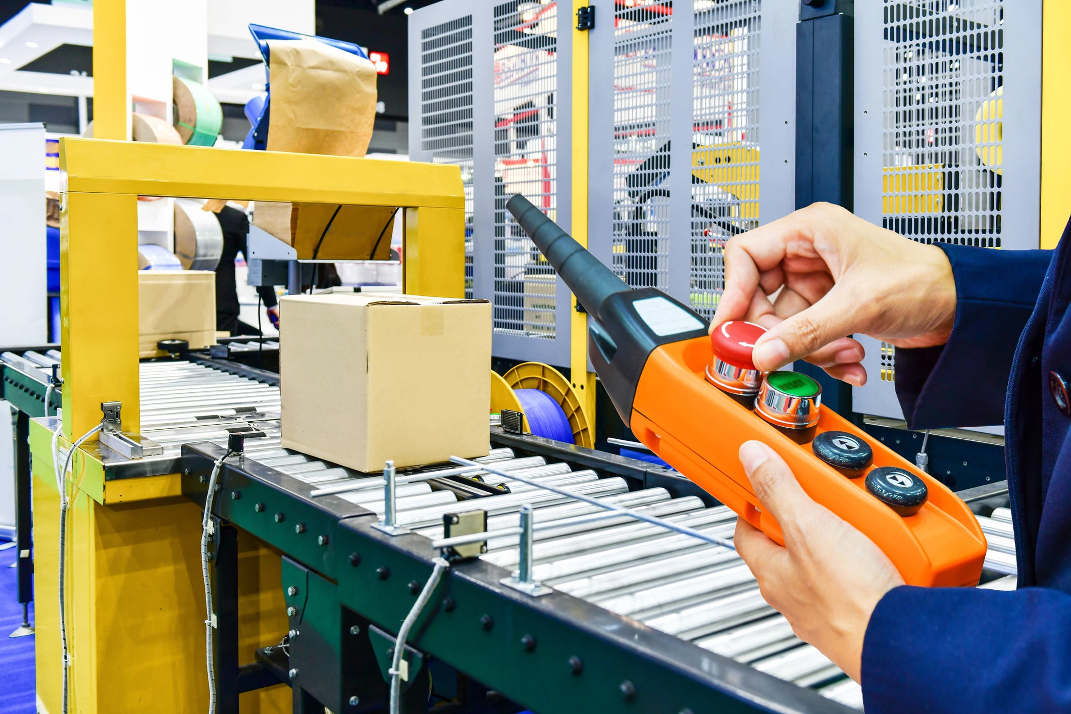 Person controlling automation on conveyor belt.