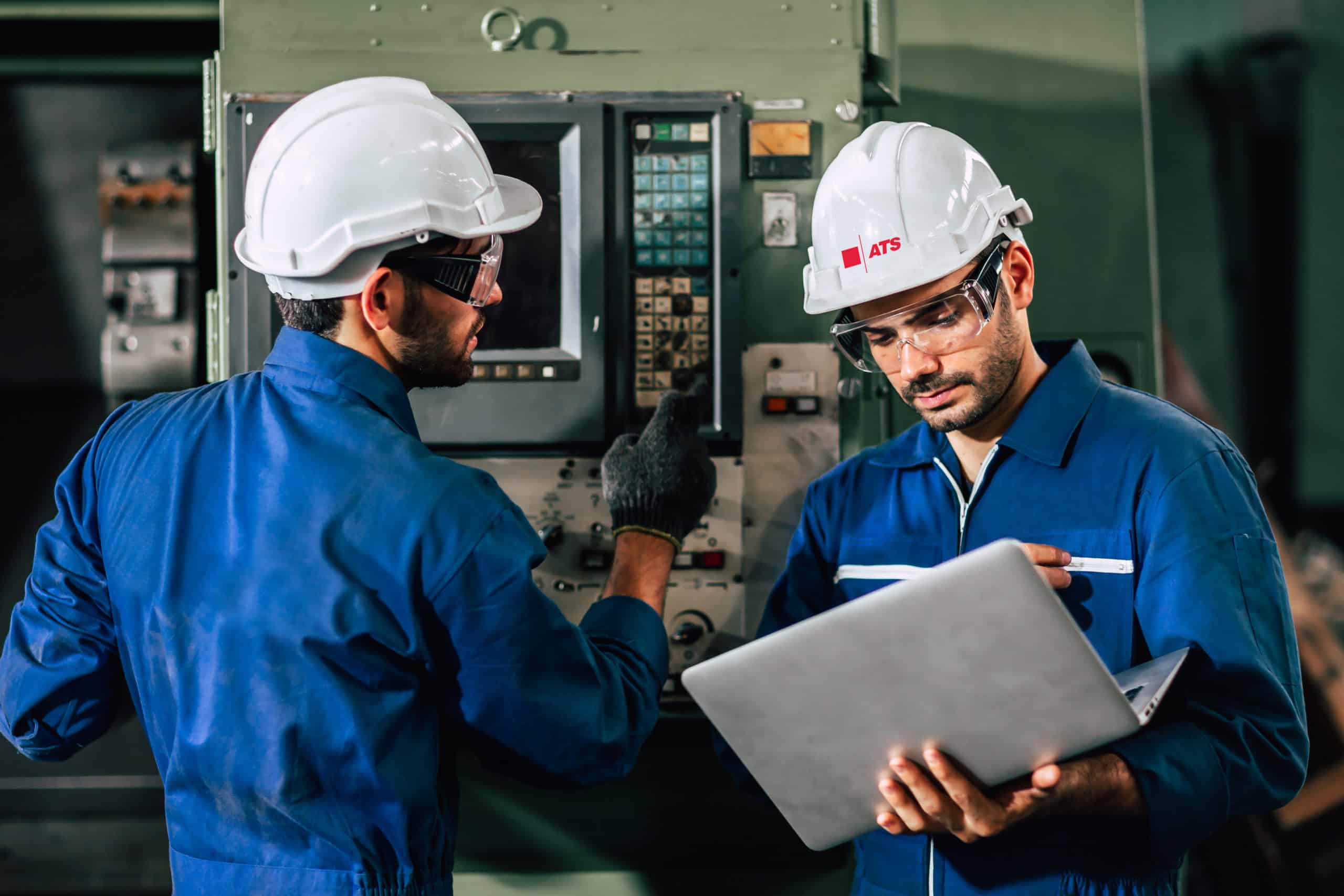 Two men in ATS hard hats.