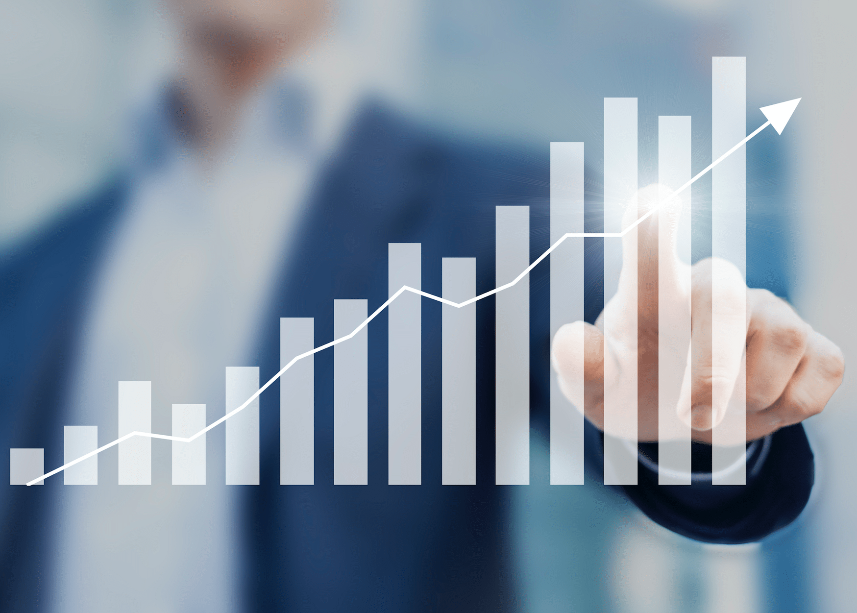 Man in suit pointing on graph.