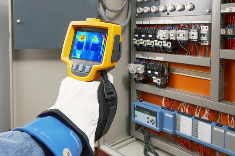 Hand using scanner to complete thermographic testing