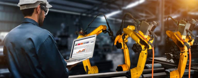 ATS worker on a laptop in a factory