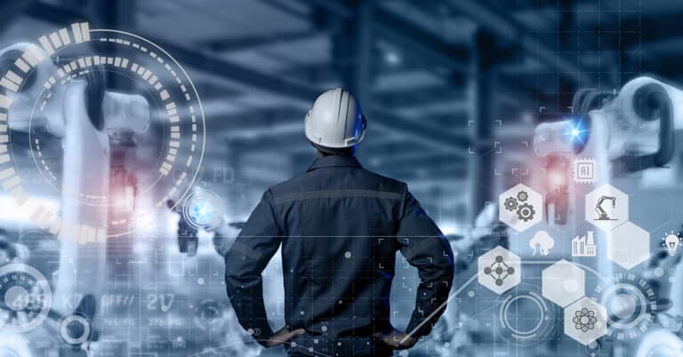 Engineer standing in front of robot in manufacturing and using automation robot with augmented mixed virtual reality and artificial intelligence.