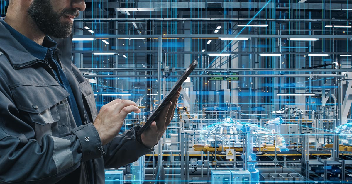 Car Factory Engineer in Work Uniform Using Tablet Computer.