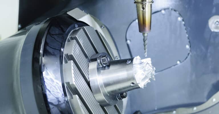 The five-axis Computer Numerical Control (CNC) machine while cutting sample aerospace part.