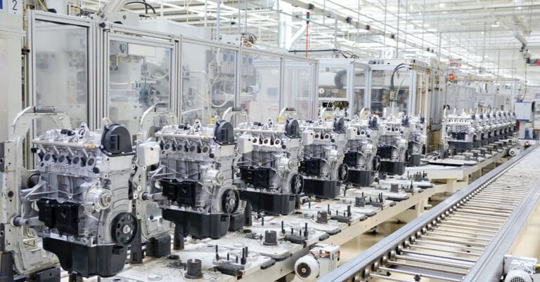 Production assembly line for manufacturing of the engines in the car factory.