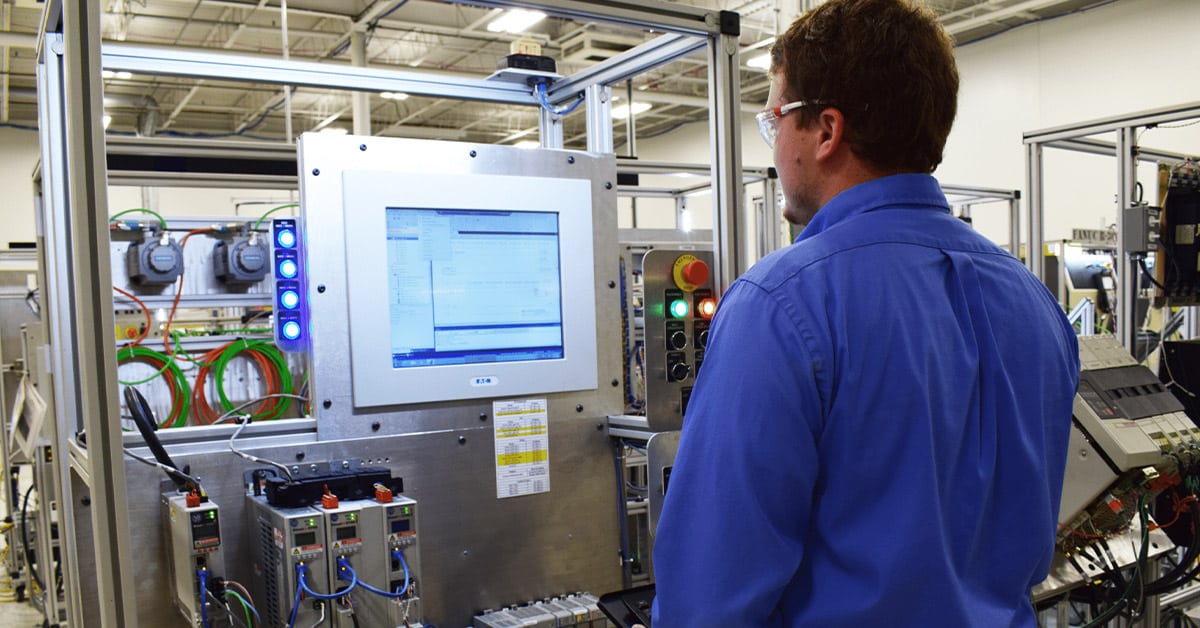 Technical Intern Collin Mormann working on an Allen-Bradley Kinetix 5700 test stand.