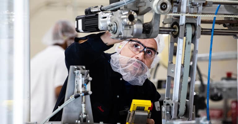 ATS technician in CPG facility checking equipment