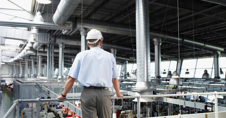 Manufacturing manager overlooking the production floor.