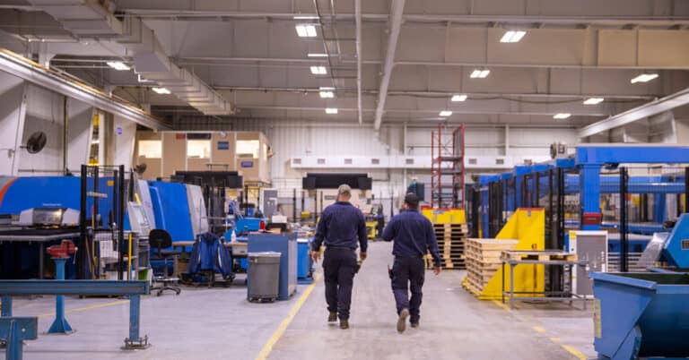 Two ATS technicians assessing the manufacturing floor