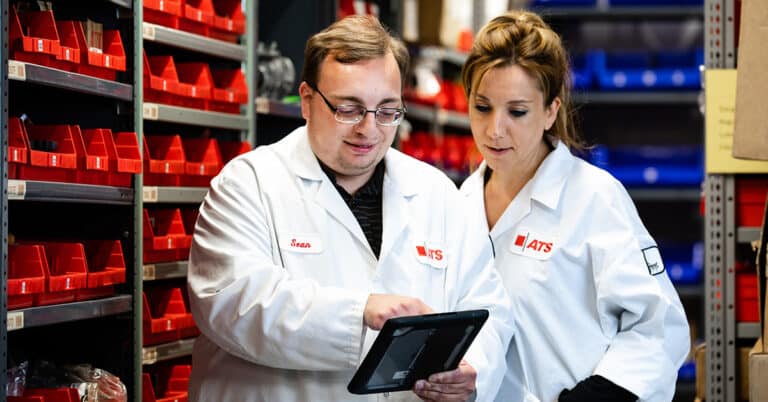 Two ATS technicians using CMMS to manage inventory