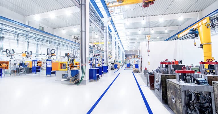 Horizontal image of huge new modern factory. Wide angle view of futuristic machines and long aisle.