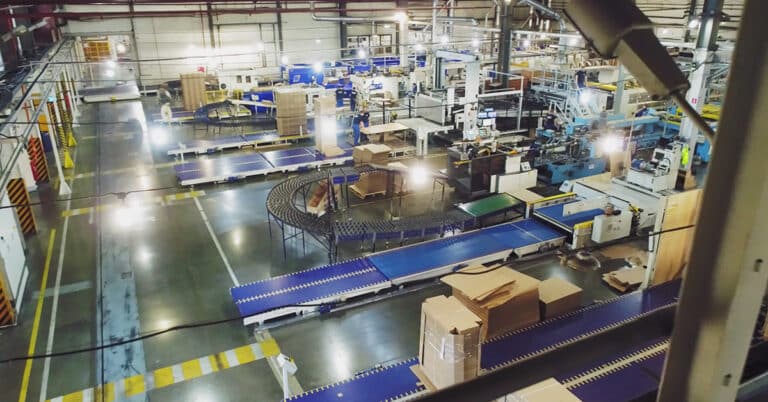 Modern papermaking plant with automated equipment. Top-down view of production line.