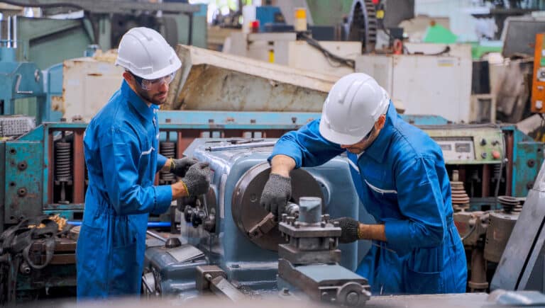 Technicians performing preventive maintenance at manufacturing plant.