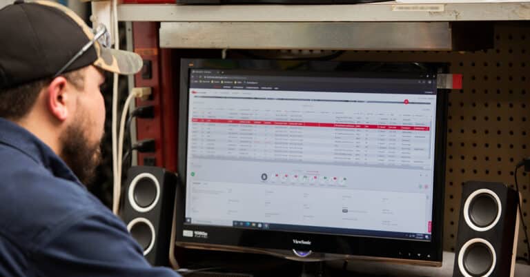 Technician submitting a work order on desktop computer.