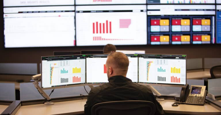 ATS reliability expert analyzing equipment health on computer monitors.