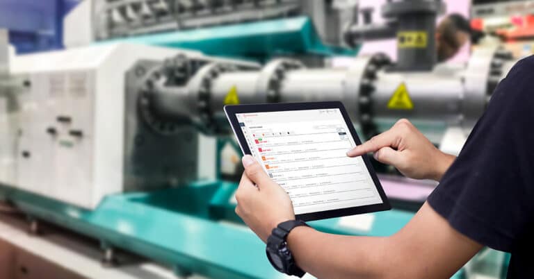 Technician holding iPad viewing Reliability 360 dashboard.