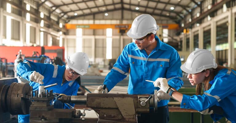 Team work of technicians together with factory mechanical engineers are inspecting machinery on the production line to plan annual maintenance.