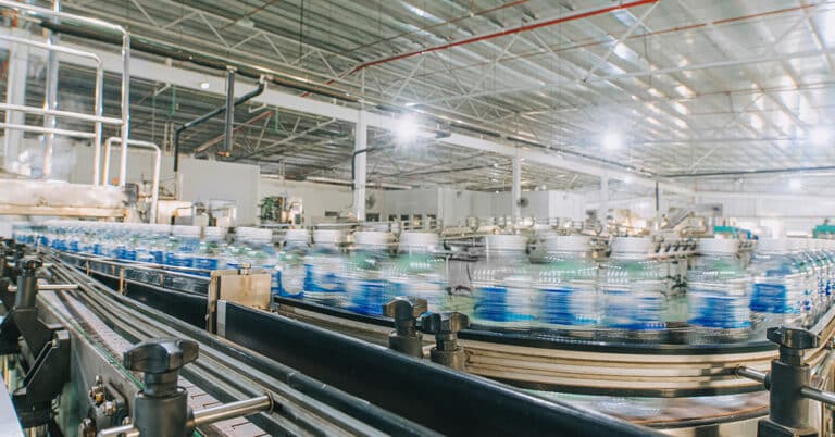 Mineral water factory production line at finishing line in a row bottle moving queuing for labelling packing.