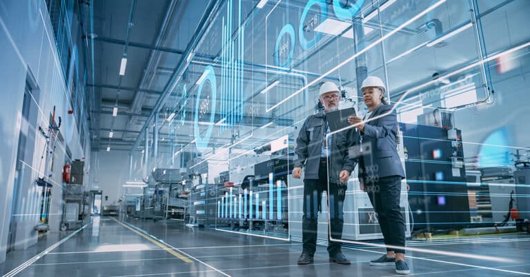 Two industrial engineers using a tablet. Industry 4.0 concept image.
